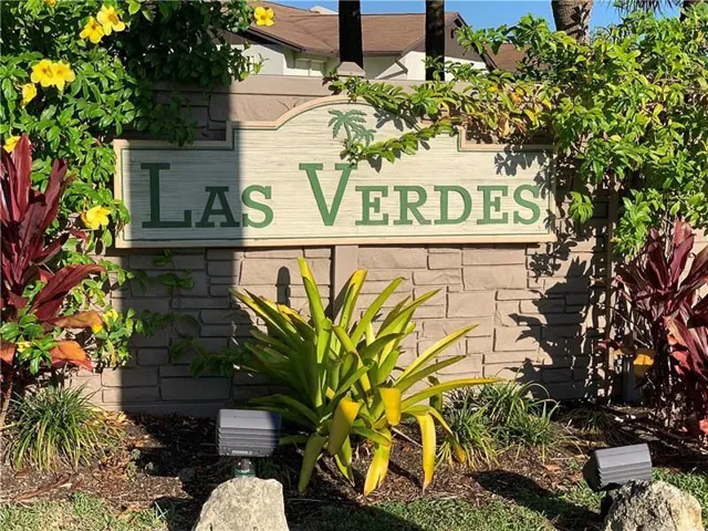 Community signage featuring a stone-look base with a decorative plaque
