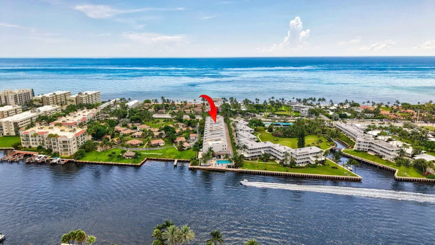 Waterfront property featuring direct ocean access, a bright blue ocean backdrop, and surrounded by canals