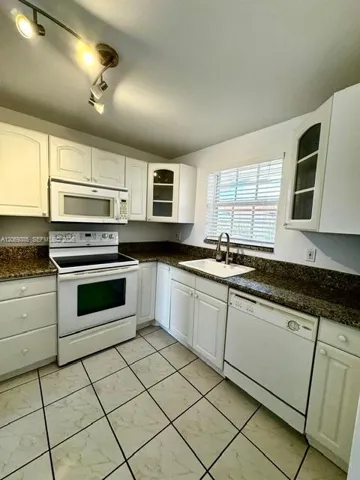Credible kitchen space with view of Courtyard