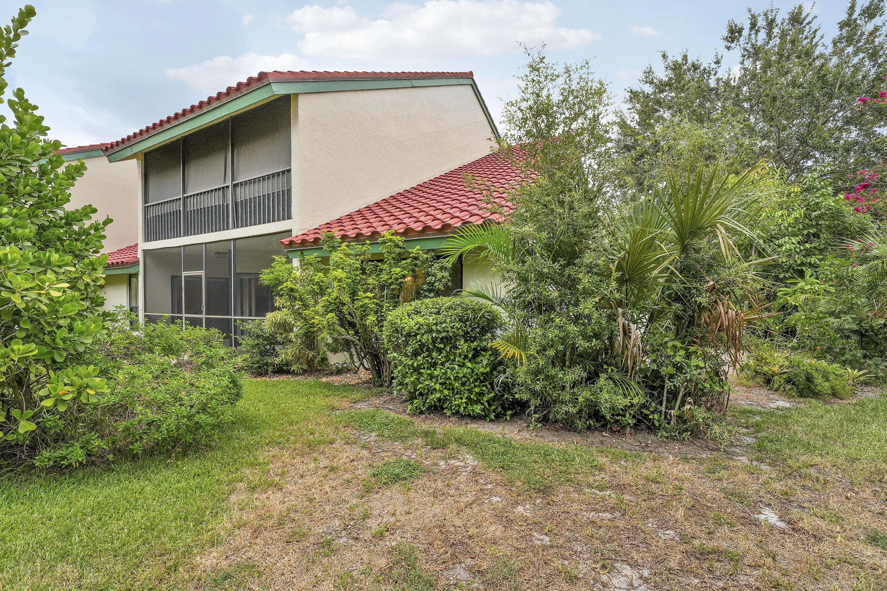 Corner unit surrounded by mature landscaping