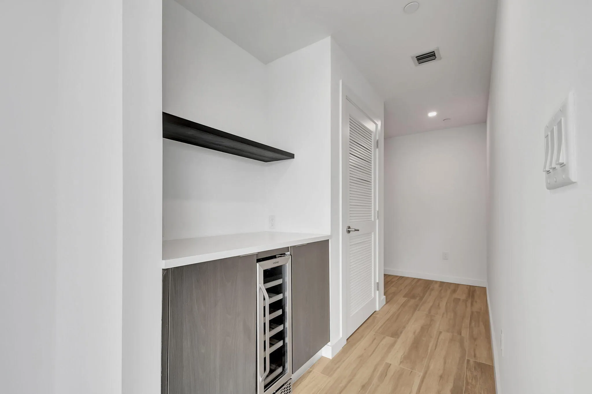 Dry bar and wine storage in entrance foyer