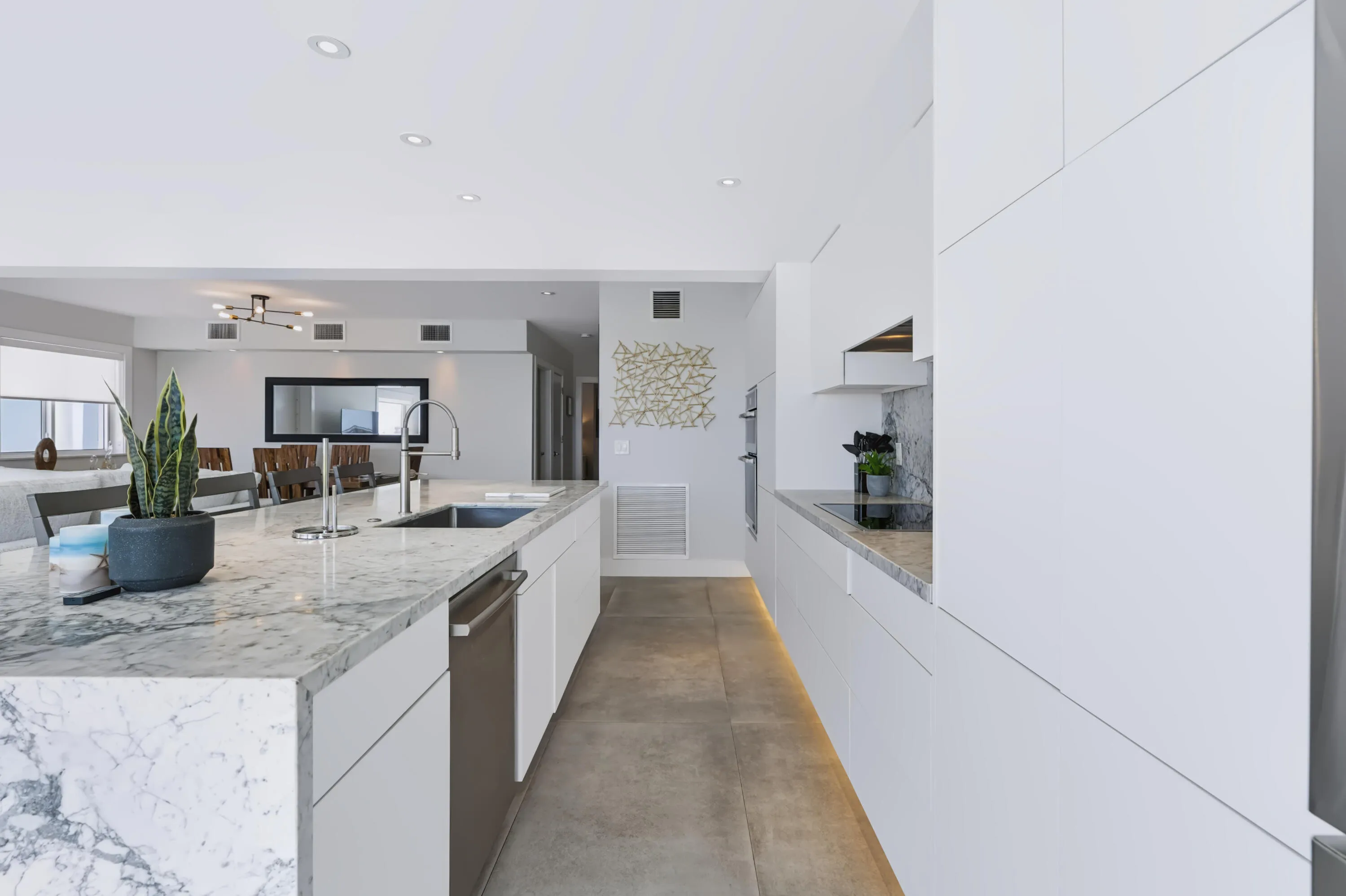 Kitchen island with a stainless steel sink, gooseneck faucet, and integrated dishwasher