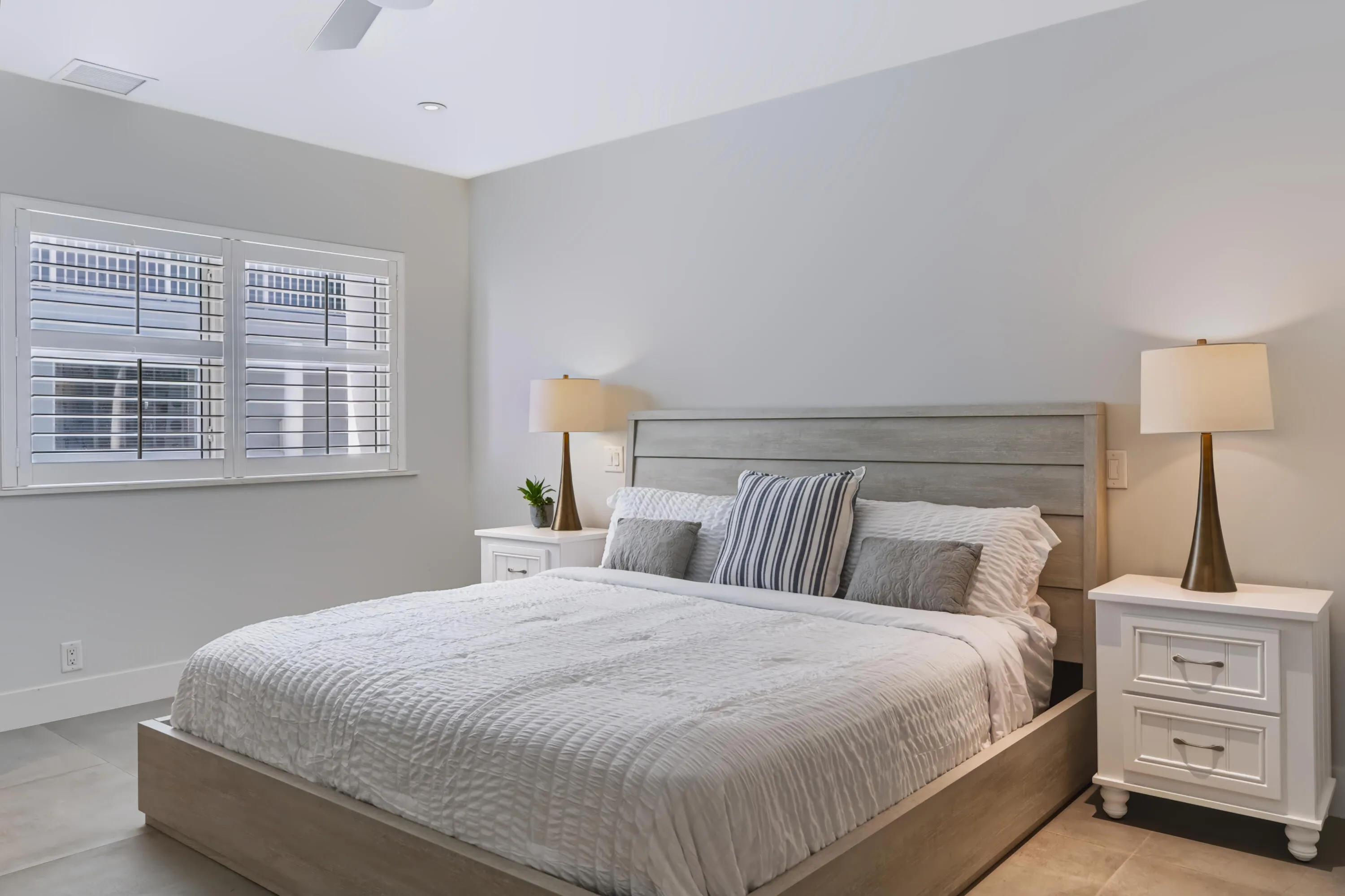 Recessed lighting, ceiling fan, and window with plantation shutters