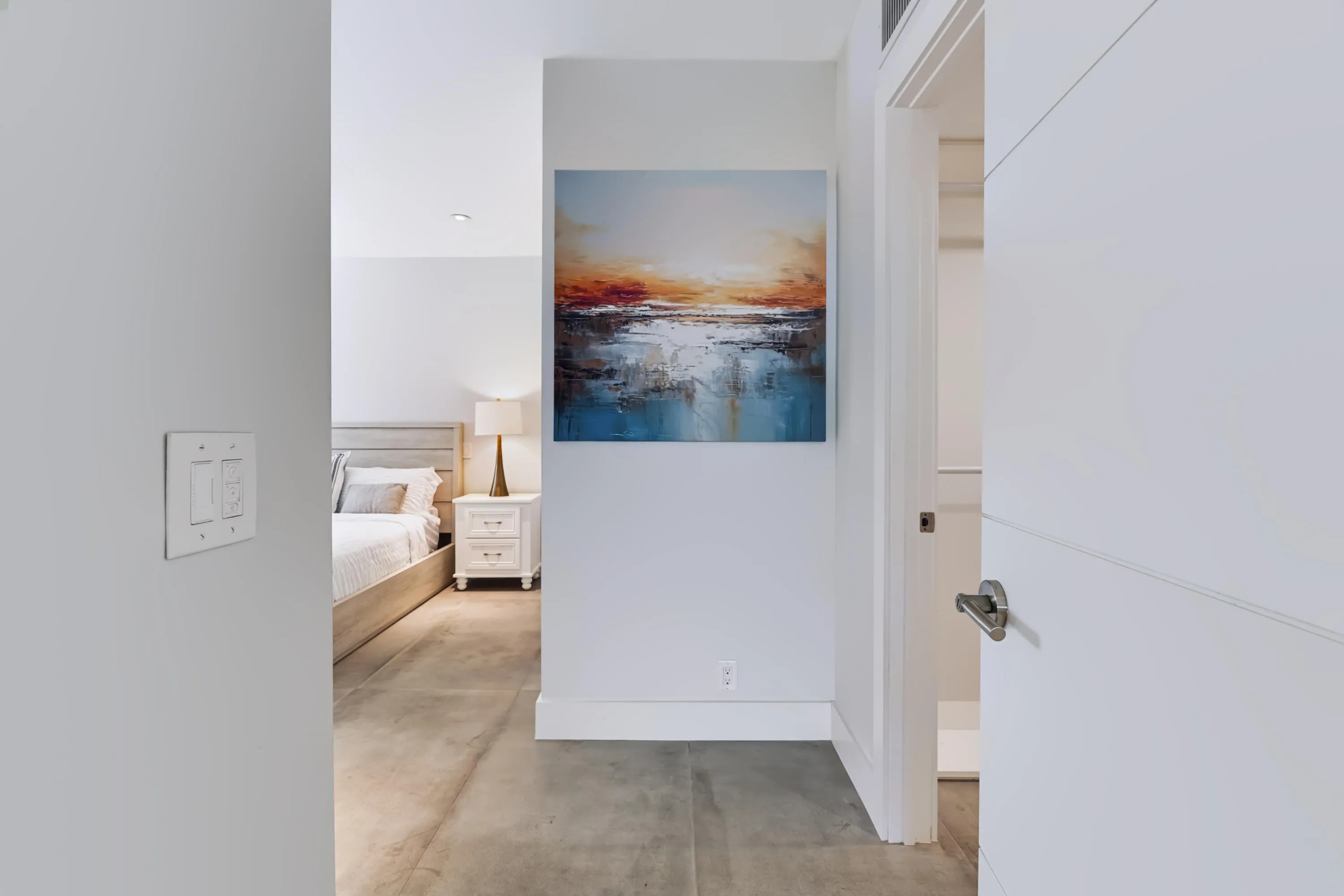 Recessed lighting, light gray wall paint, and concrete flooring