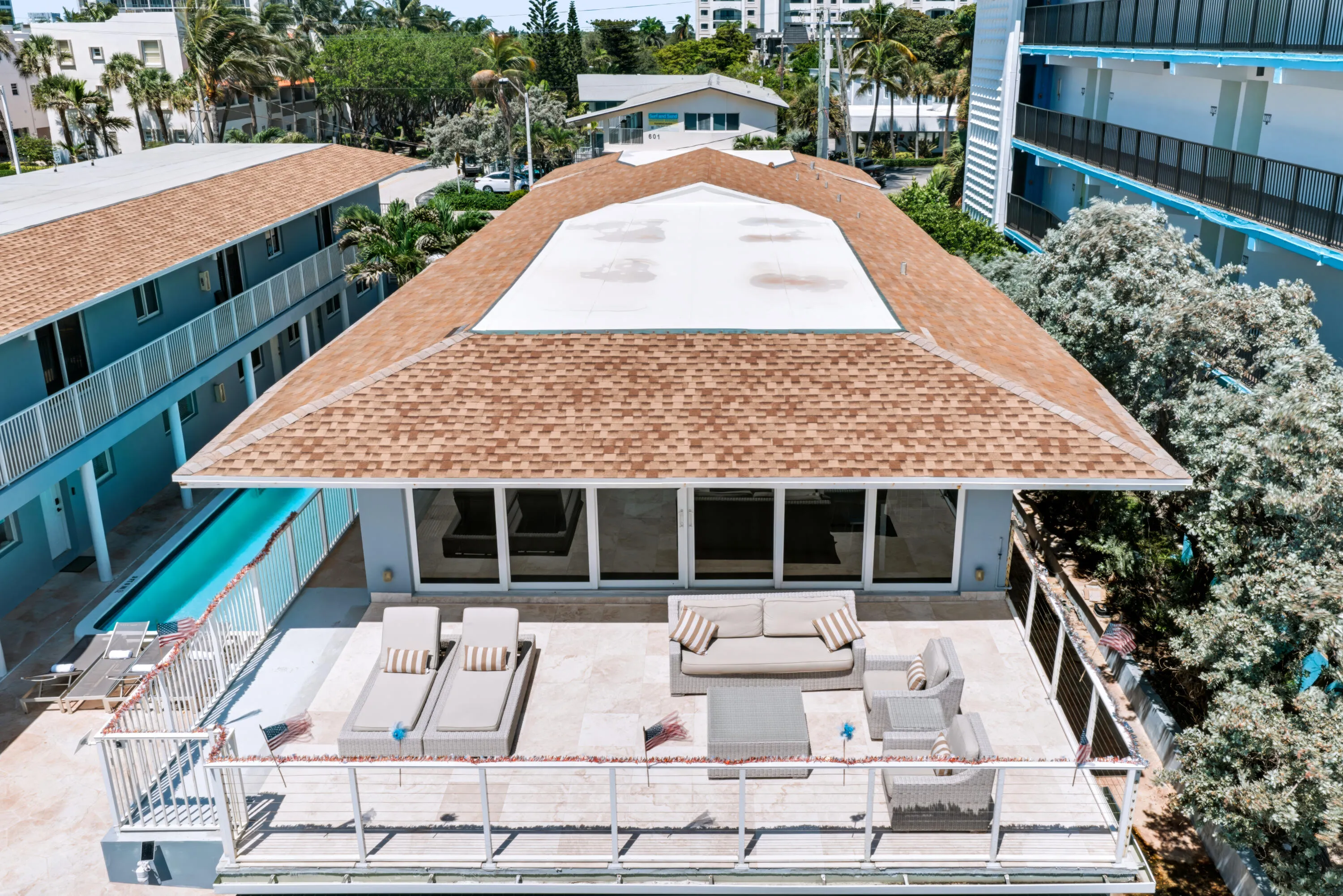 Expansive outdoor terrace with a white railing and tiled flooring