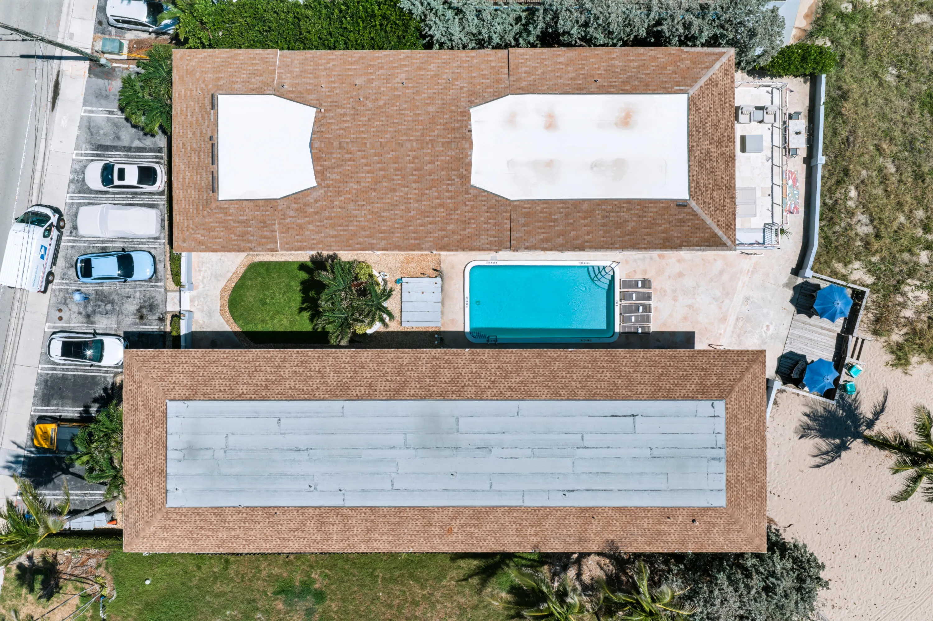 Property featuring a swimming pool, paved patio, and a grass area