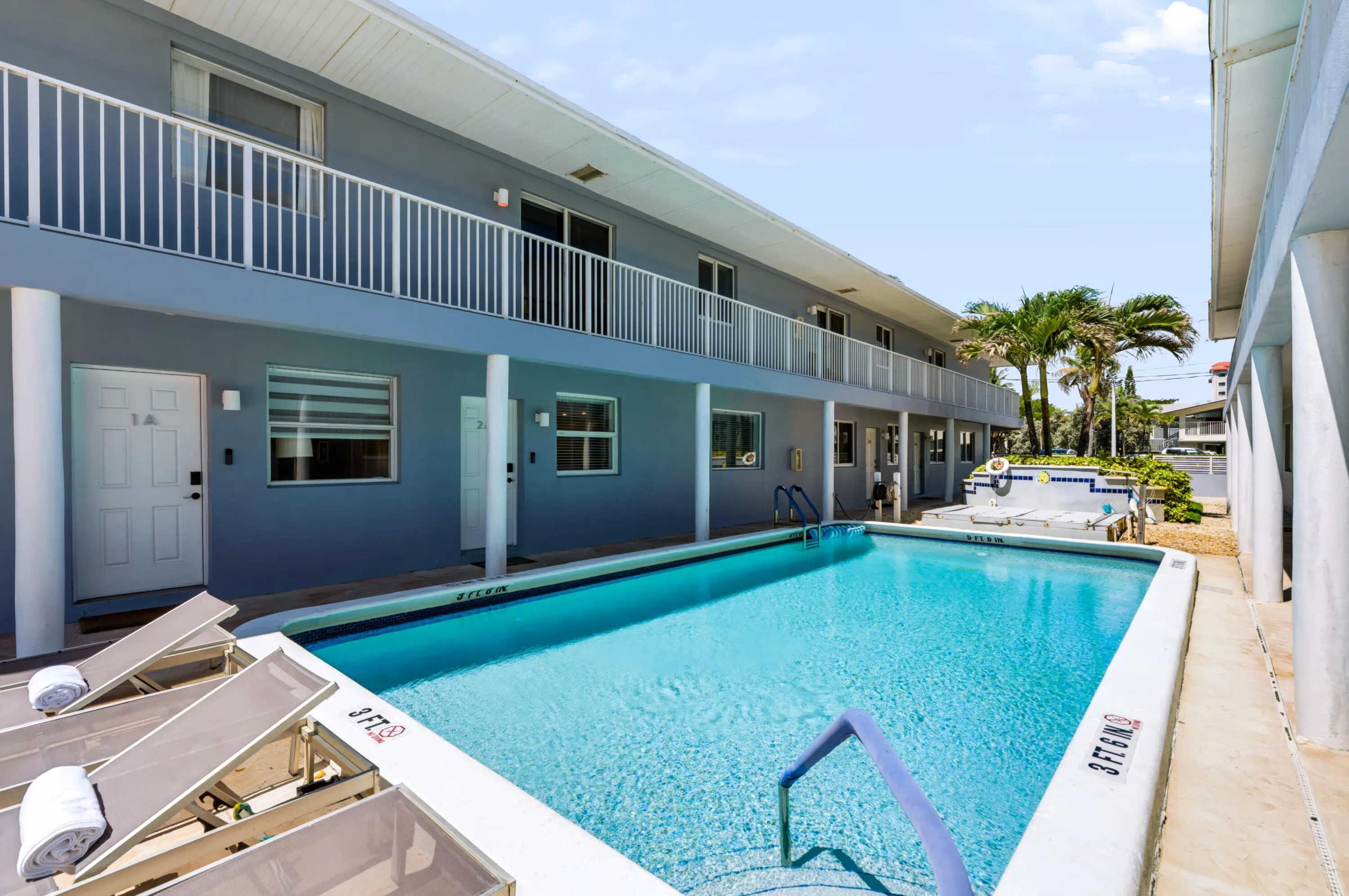 Outdoor swimming pool with integrated steps, surrounded by a concrete deck