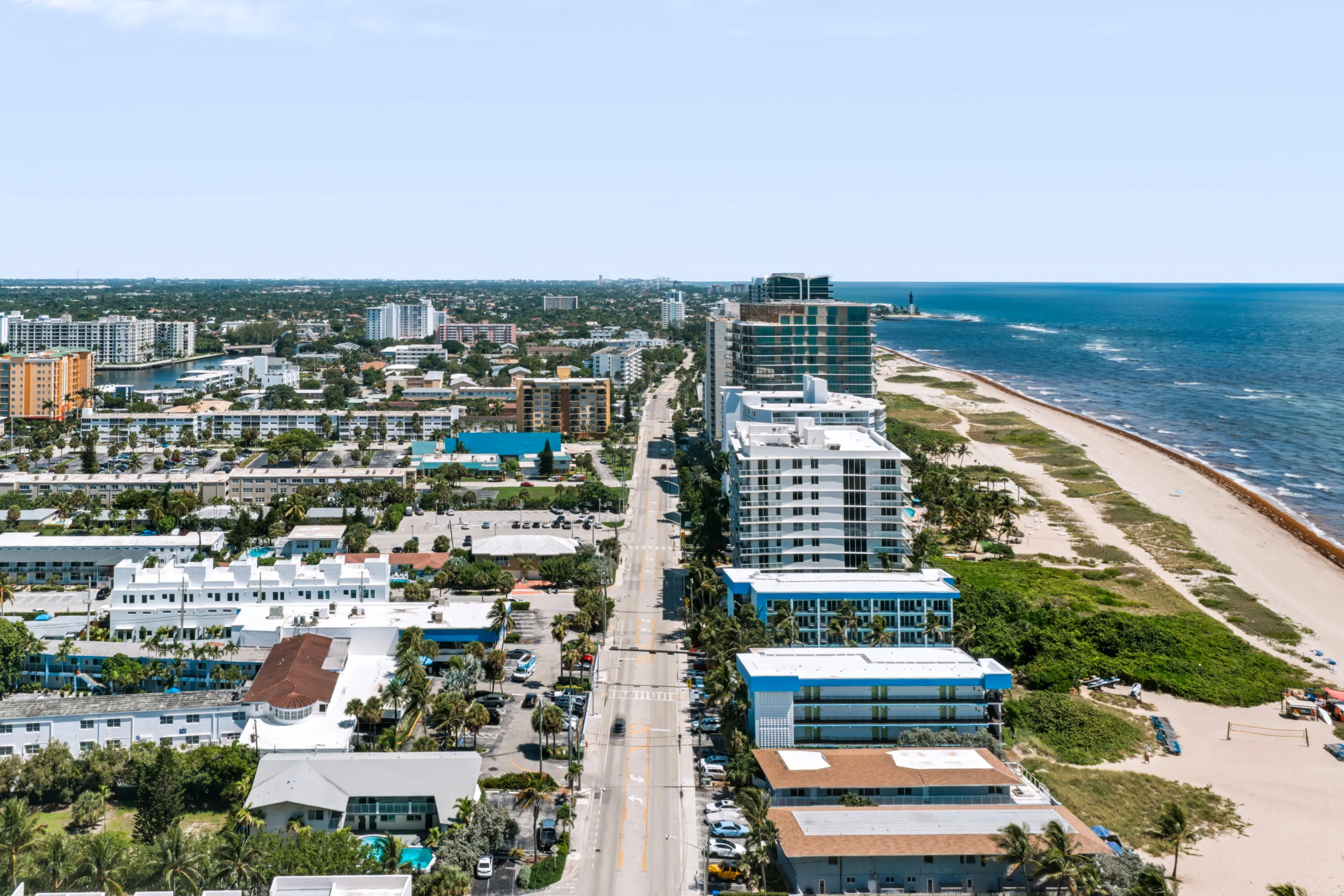 Coastal urban setting featuring a prominent beachfront, Atlantic Ocean frontage, and surrounding residential structures