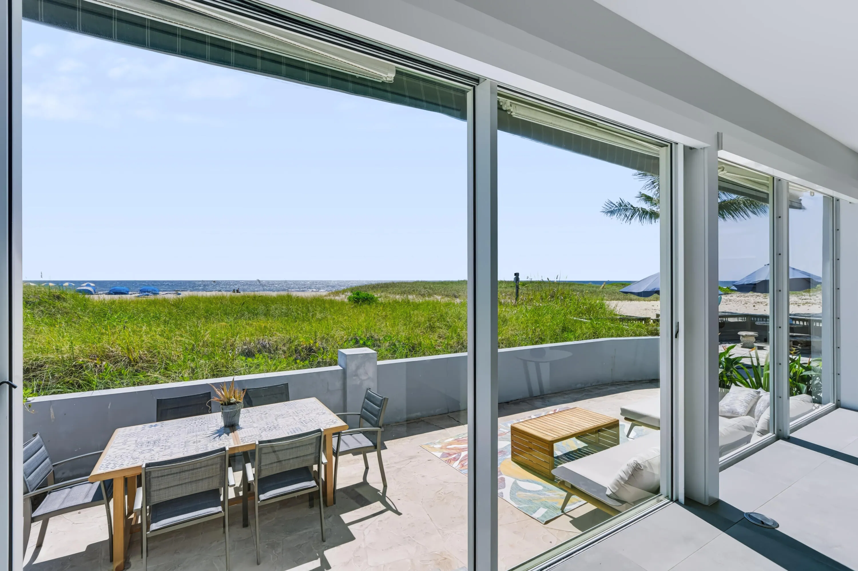 Expansive oceanfront setting with a sand beach and natural vegetation