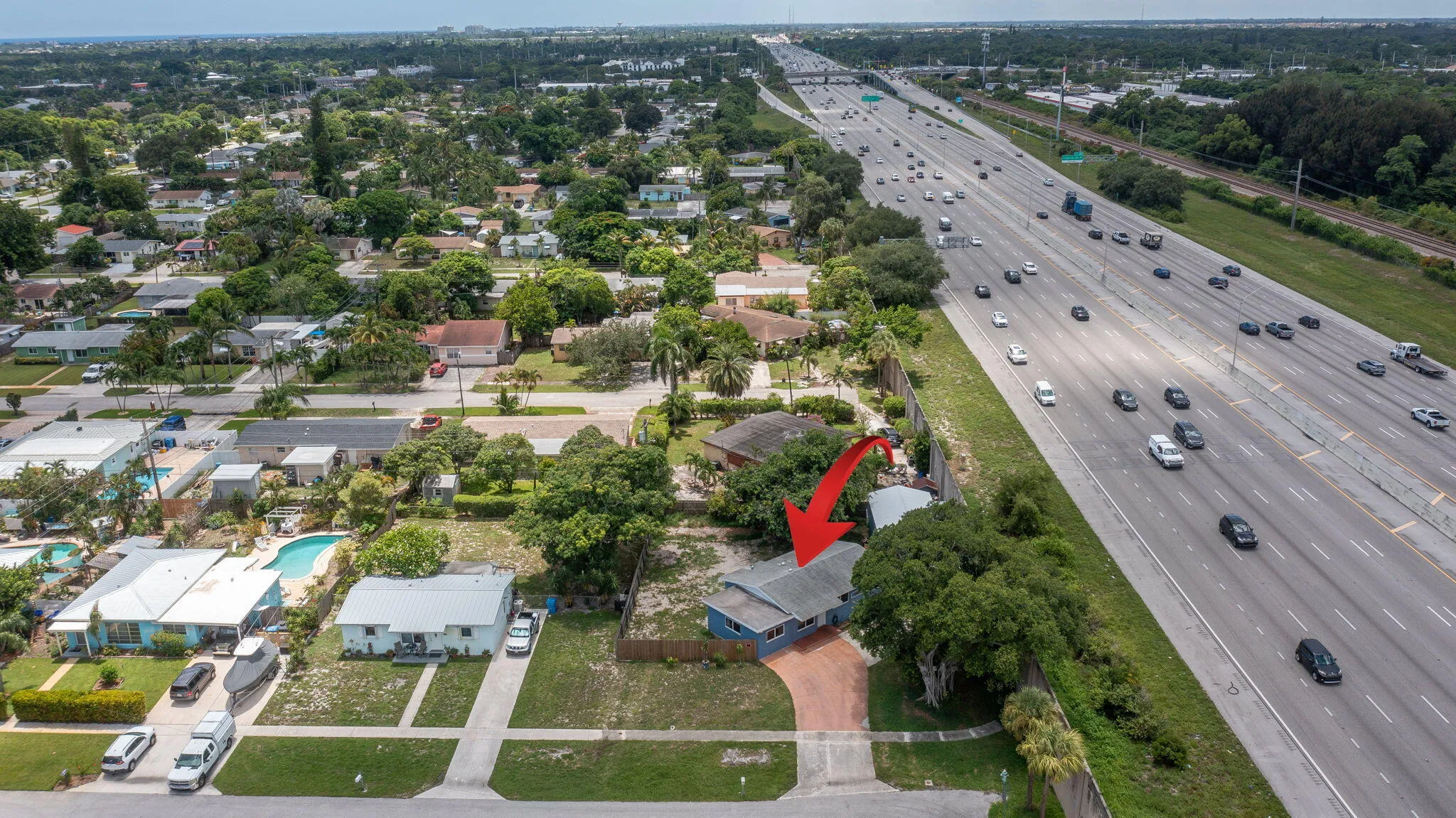 Rear of property backs to I-95 and is separated by a large concrete sound barrier wall.