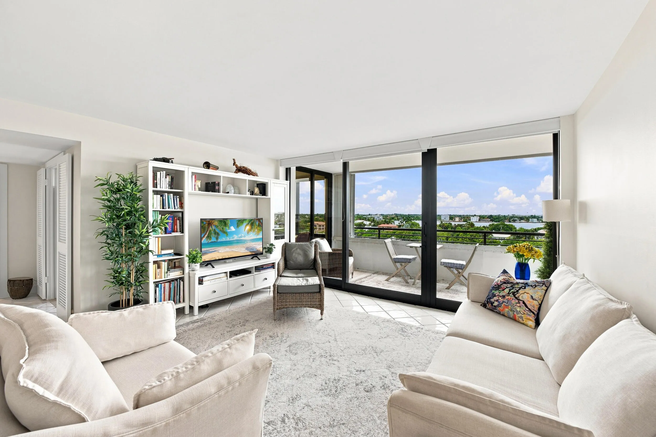 Living area with expansive glass sliding doors opening to a private balcony
