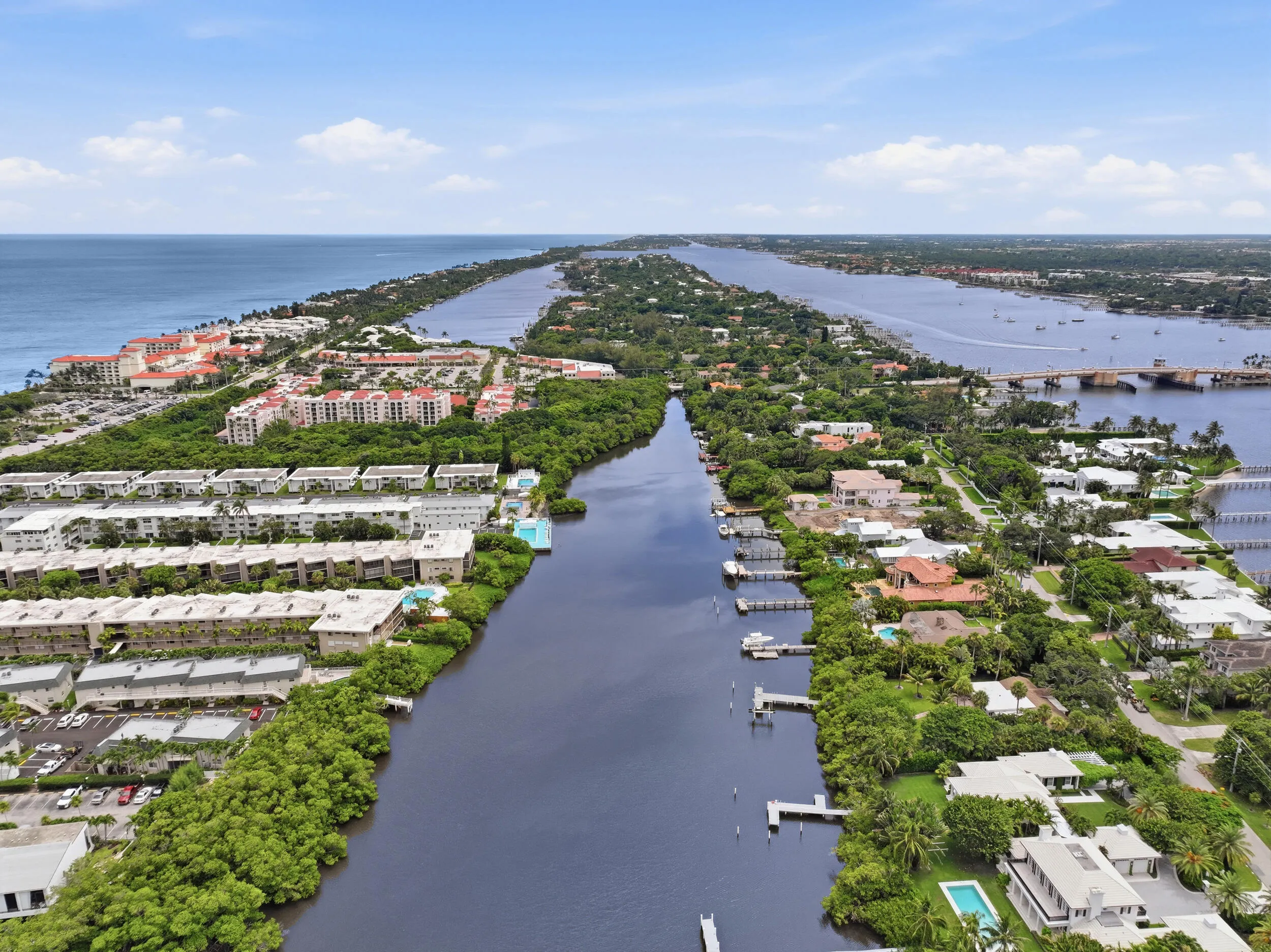 Aerial perspective showcasing waterfront properties along a canal and oceanfront
