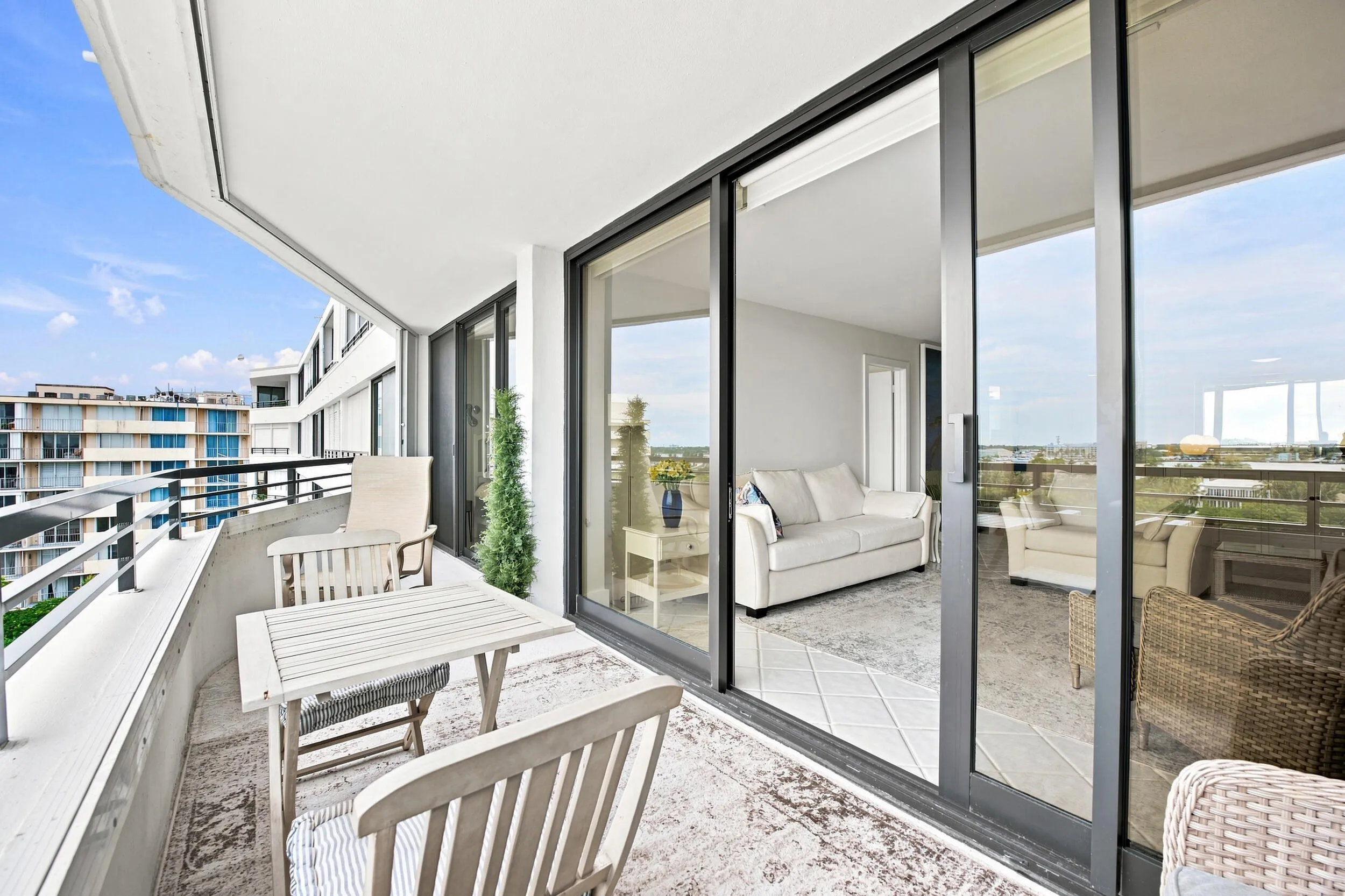 Expansive balcony with concrete flooring and a metal railing system