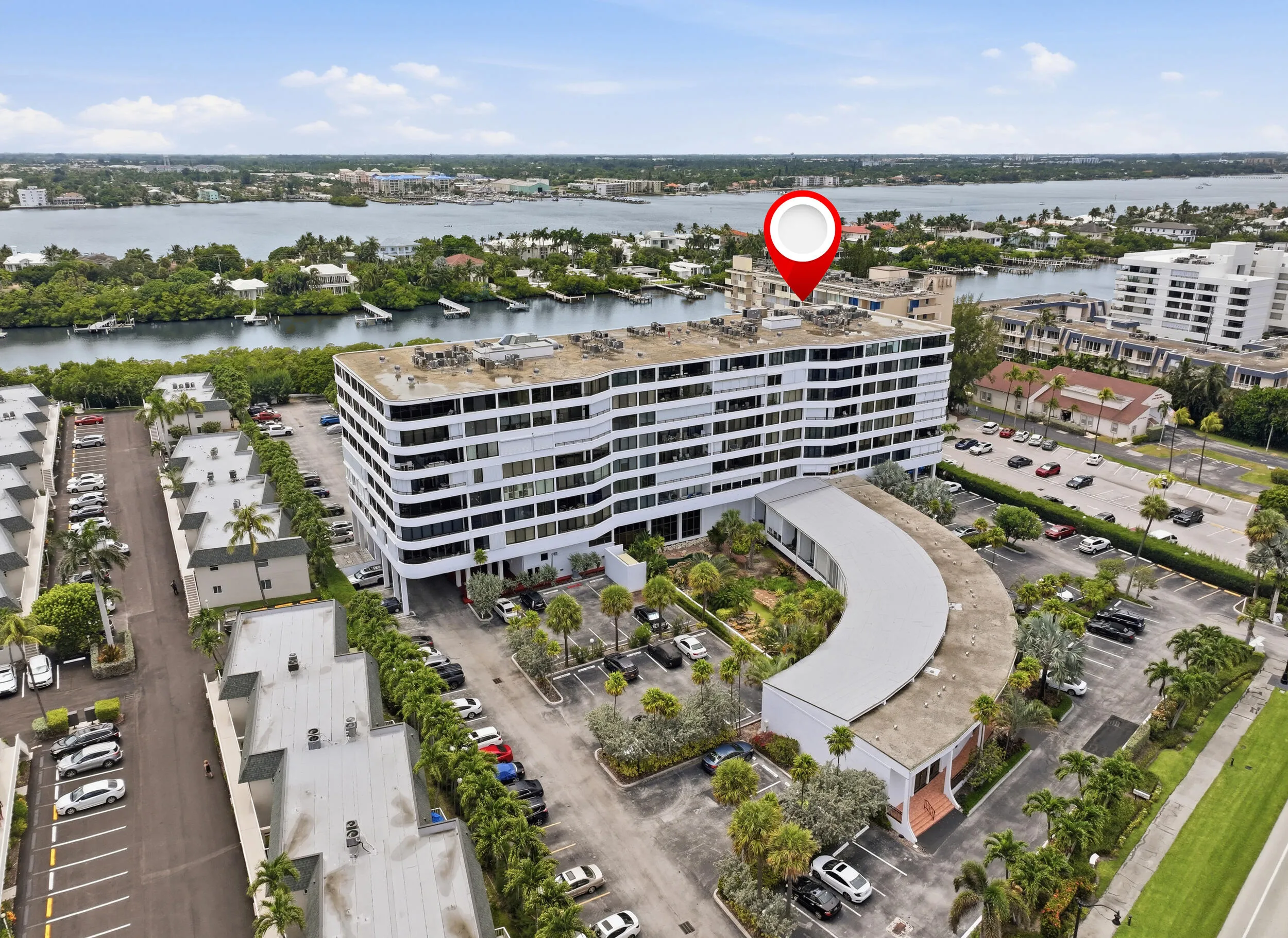 Modern multistory building featuring white exterior finishes and multiple levels of balconies