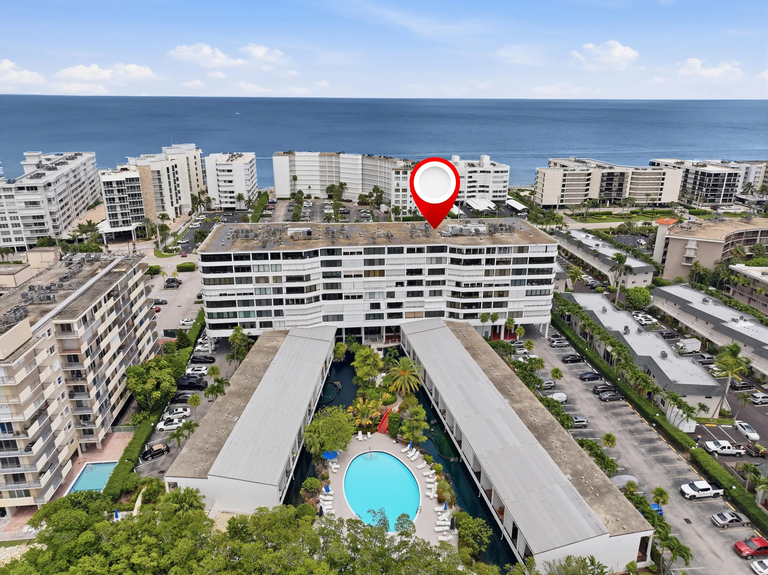Coastal high-rise property featuring multiple balconies and a clear ocean backdrop