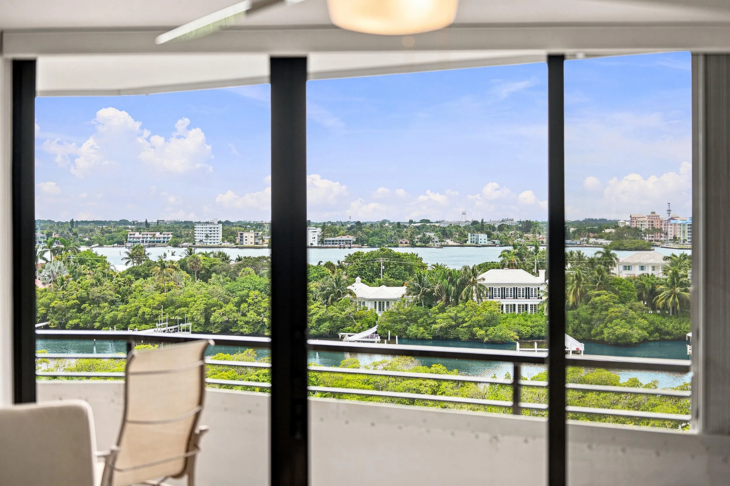 Expansive windows frame panoramic water and cityscape scenery