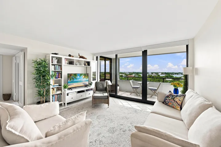 Living area with expansive glass sliding doors opening to a private balcony