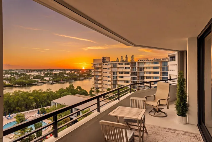 Expansive private balcony with a water backdrop