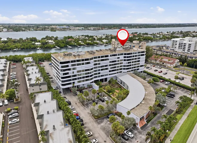 Modern multistory building featuring white exterior finishes and multiple levels of balconies
