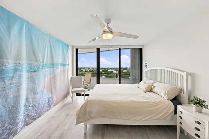 Light-toned wood-finish flooring complements white walls and ceiling