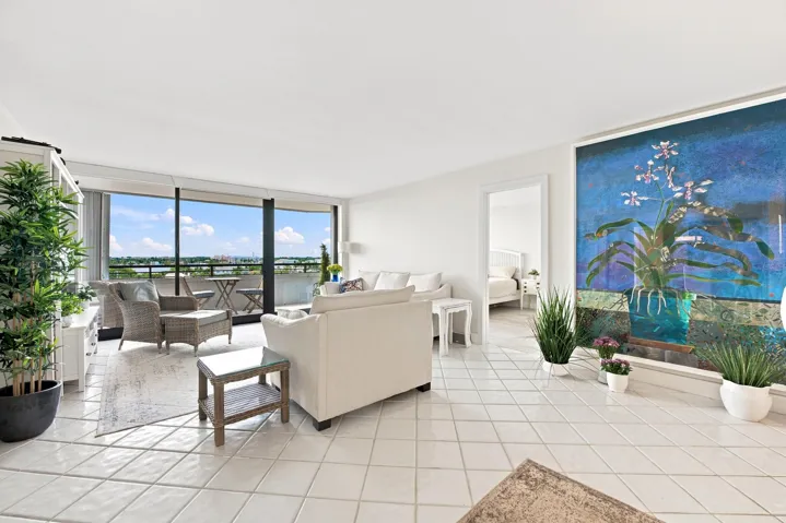 Expansive living area featuring light-toned tile flooring throughout