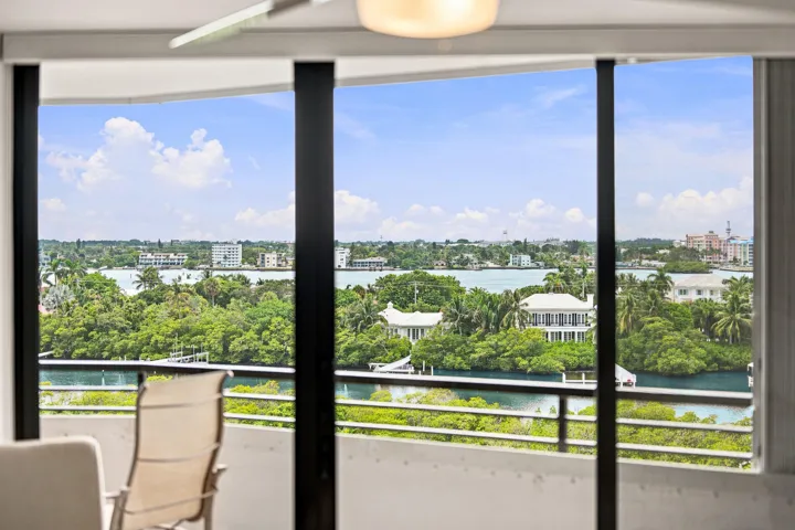 Expansive windows frame panoramic water and cityscape scenery