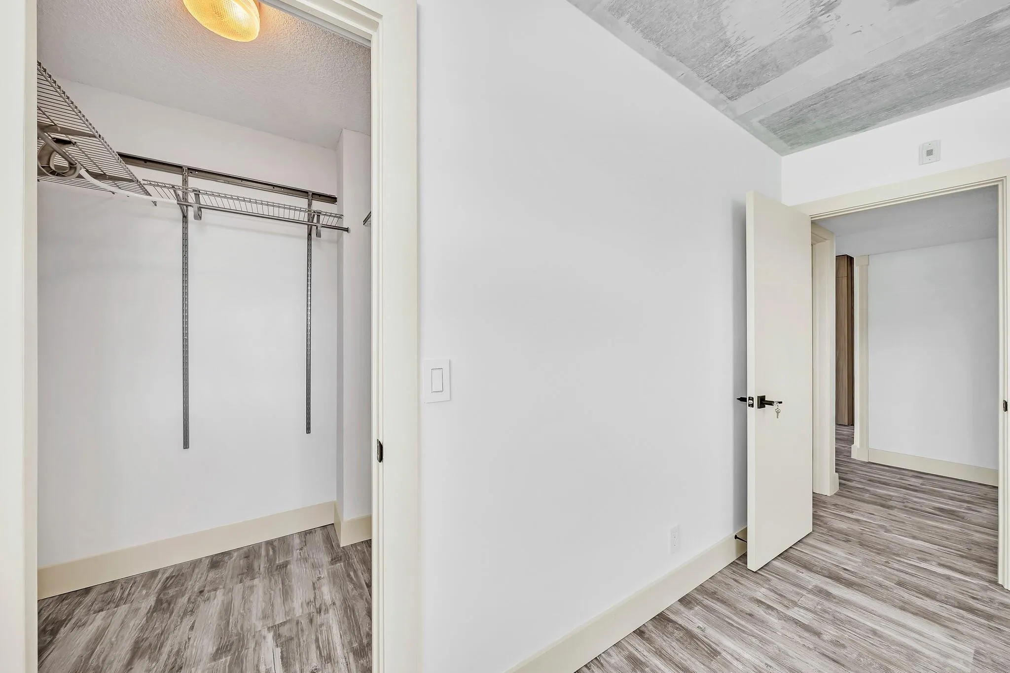 Walk-in closet with wire shelving and hanging rods