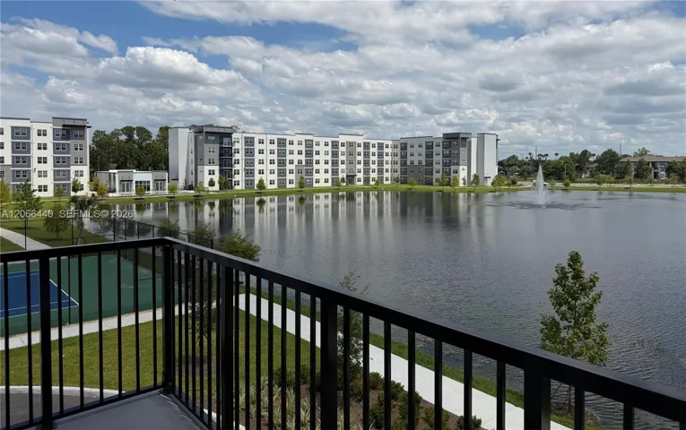 Private balcony with serene lake view, and direct sightlines to the tennis courts.