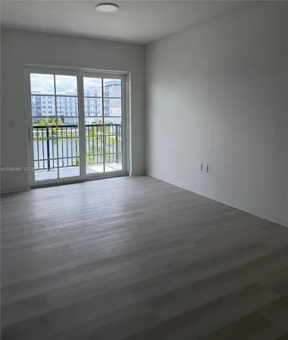 Living room with direct views of the private balcony and tranquil lake, perfect for winding down after a long day.