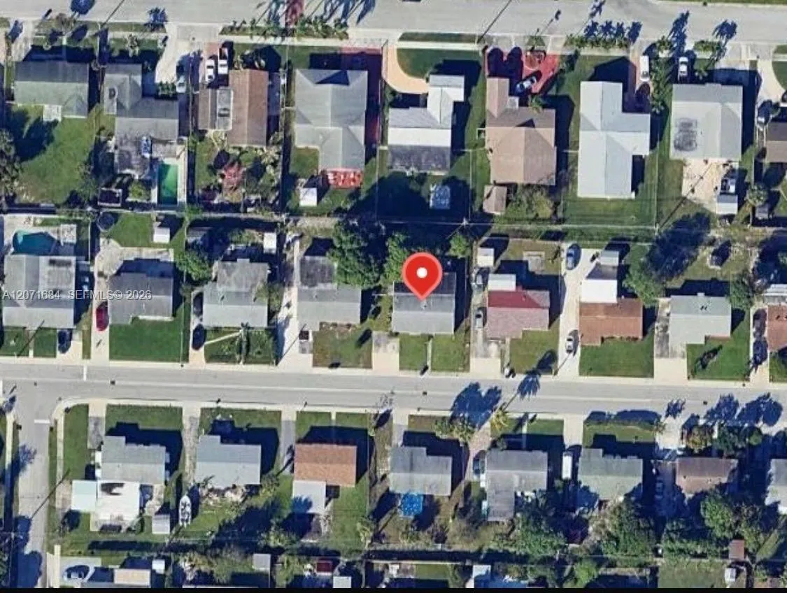Aerial view showing the property and surrounding neighborhood