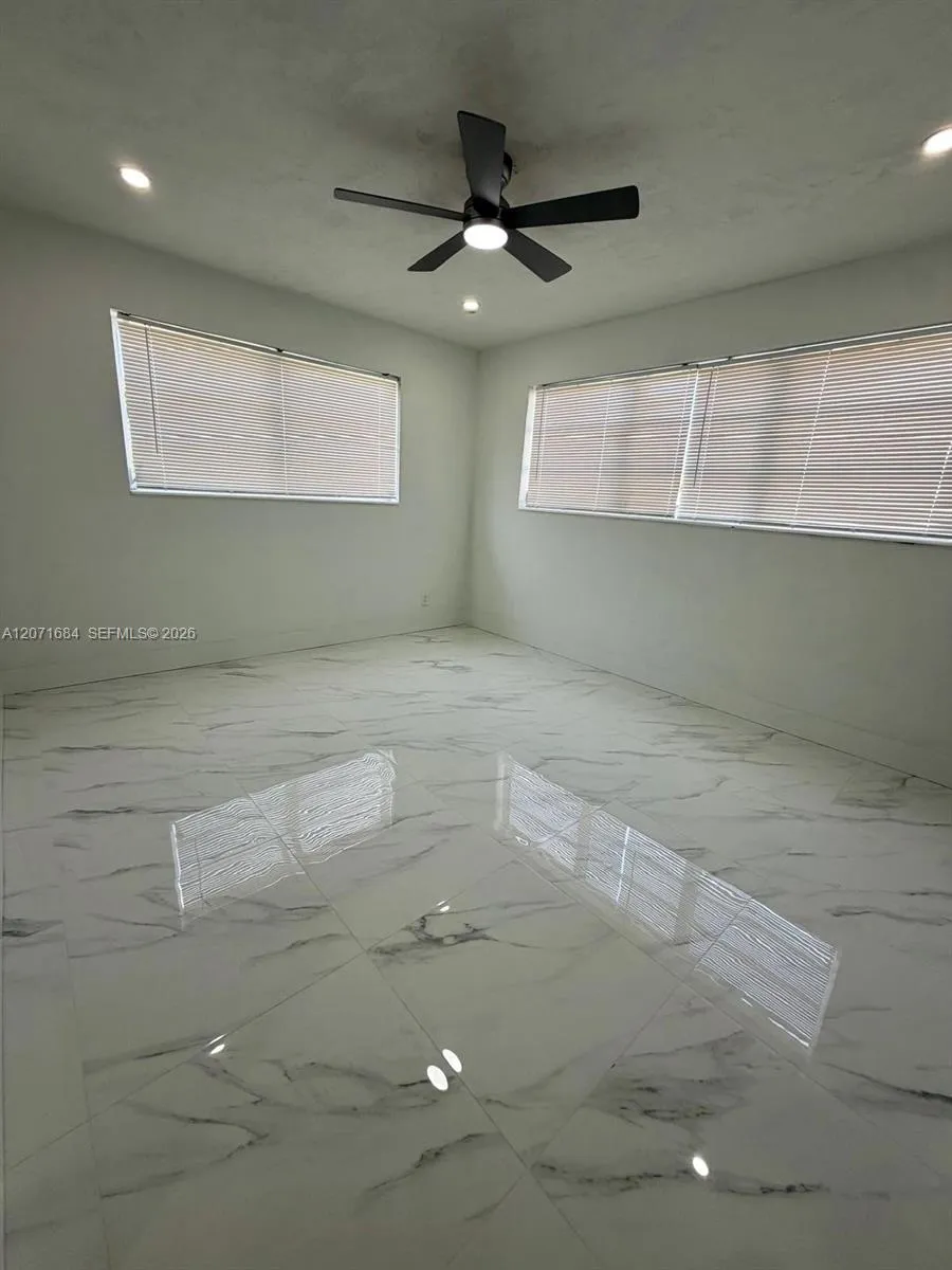 Third bedroom with tile flooring, ceiling fan and natural light
