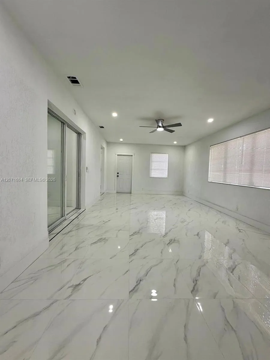 Spacious family room with tile flooring and abundant natural light