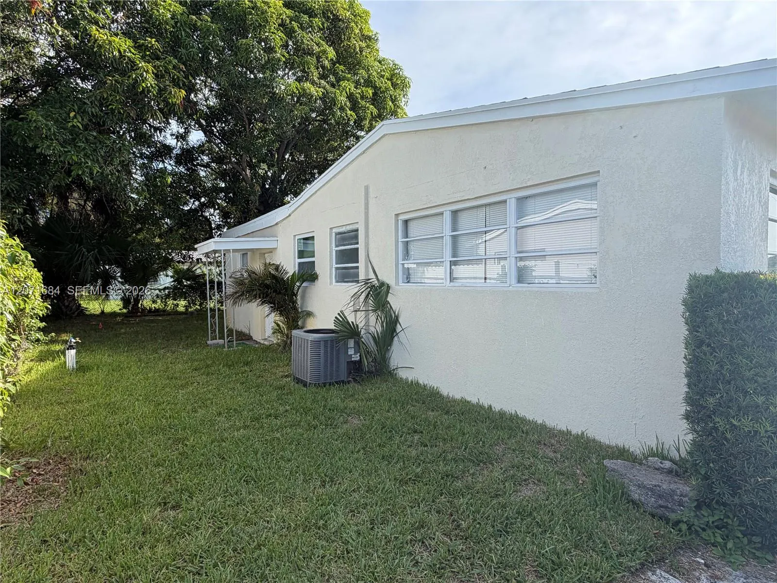Exterior side view and fenced yard