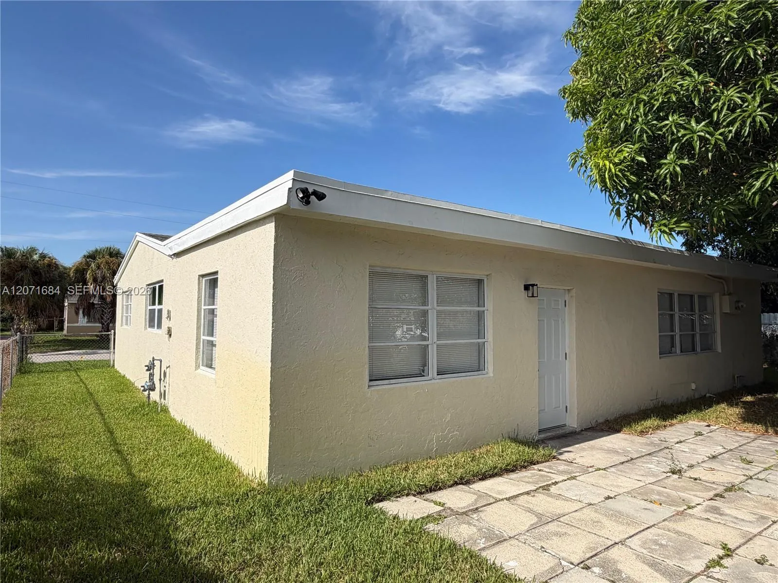Rear exterior showing separate entrance and window to additional living space