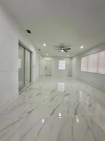 Spacious family room with tile flooring and abundant natural light