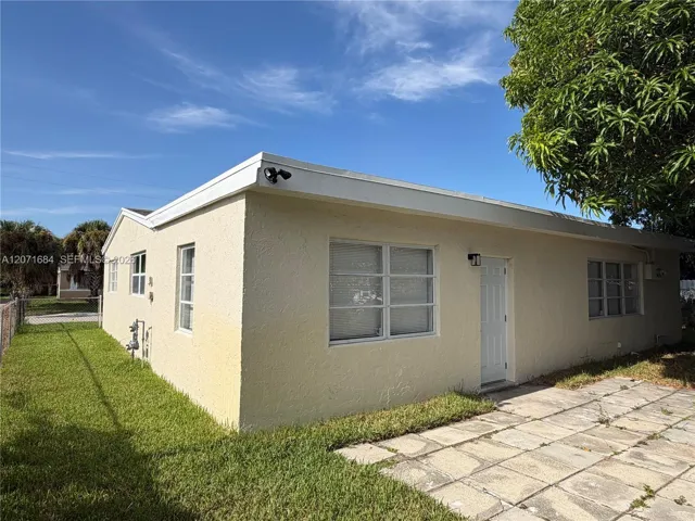 Rear exterior showing separate entrance and window to additional living space