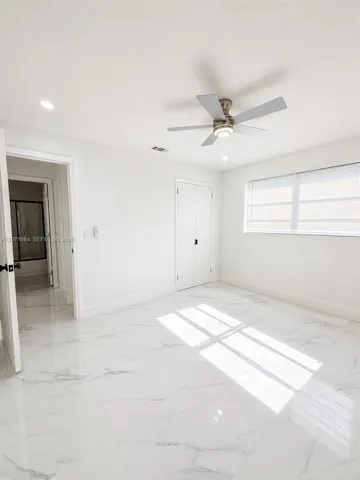 Third bedroom shown from another angle with tile flooring and natural light