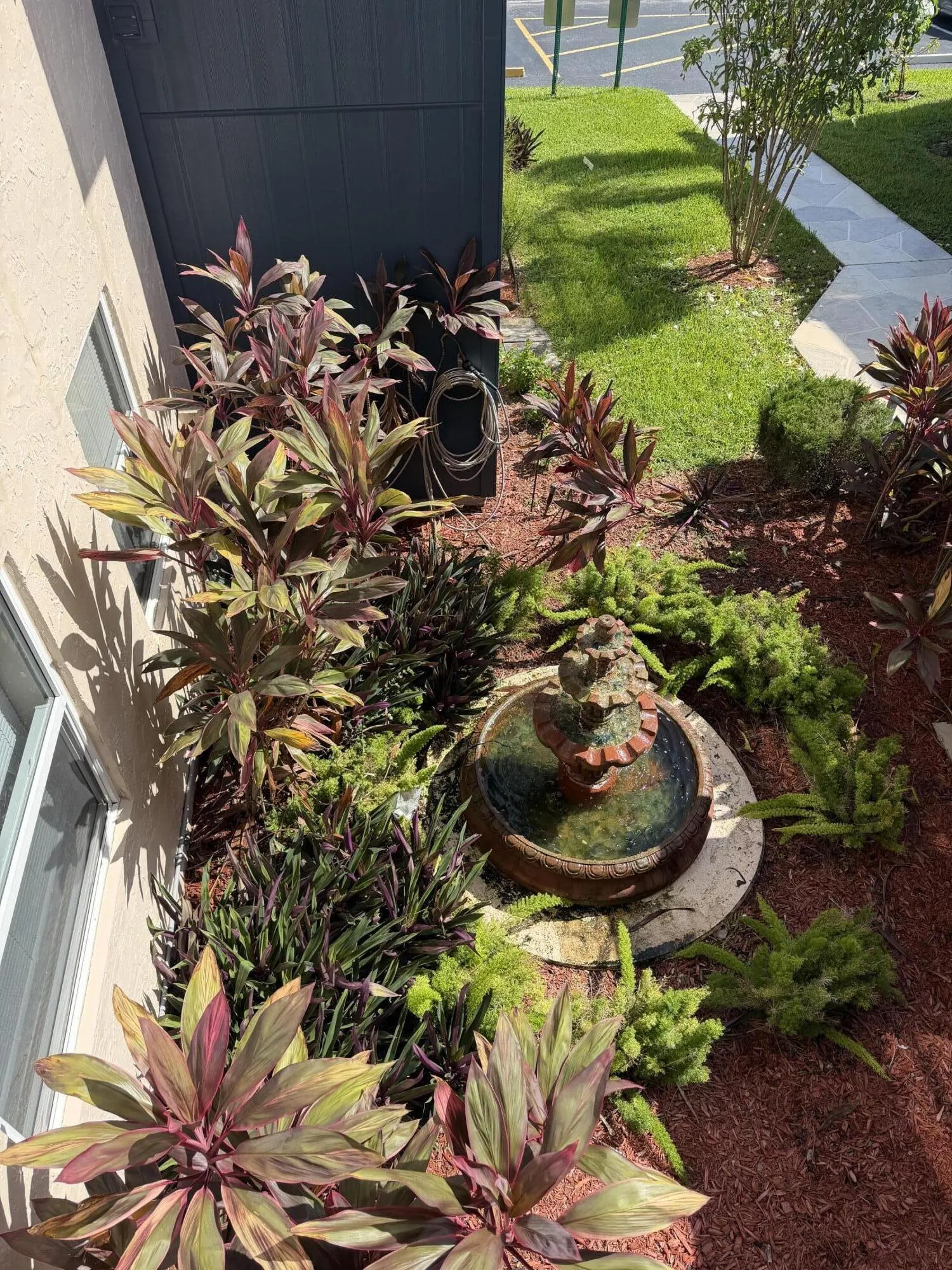 Your exterior view of a fountain and custom landscaping.