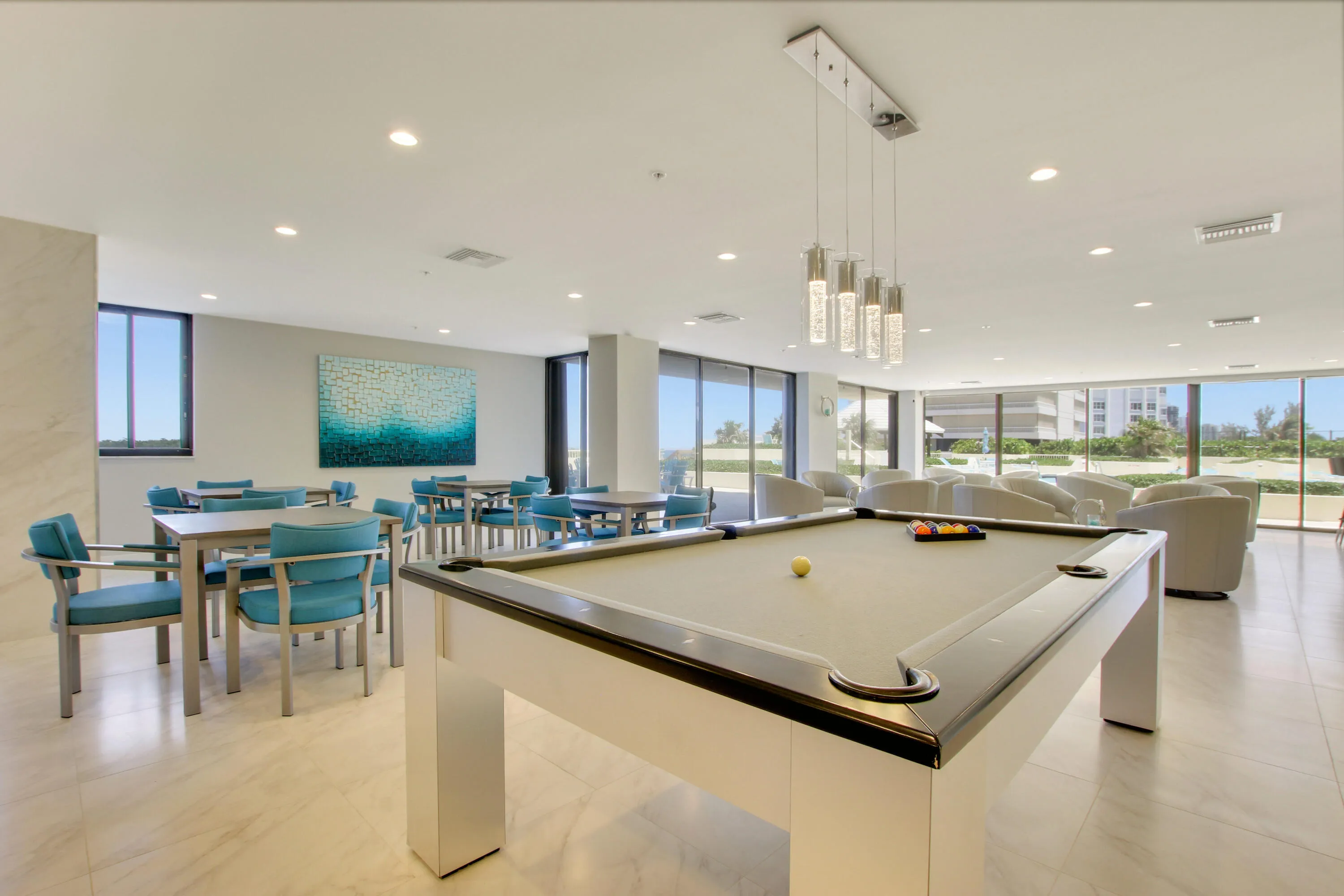 Spacious common area featuring a billiard table, recessed lighting, tile flooring, and multiple seating arrangements