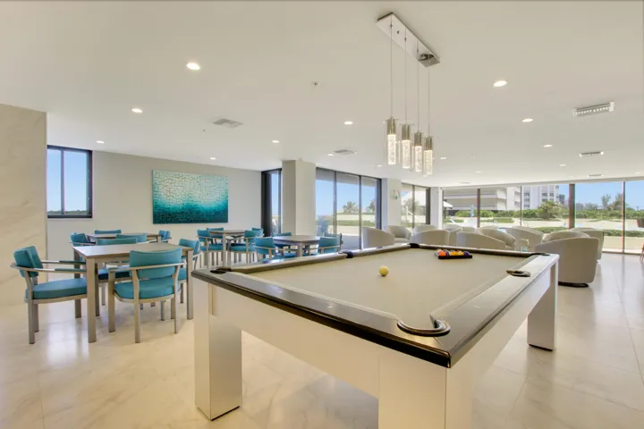 Spacious common area featuring a billiard table, recessed lighting, tile flooring, and multiple seating arrangements
