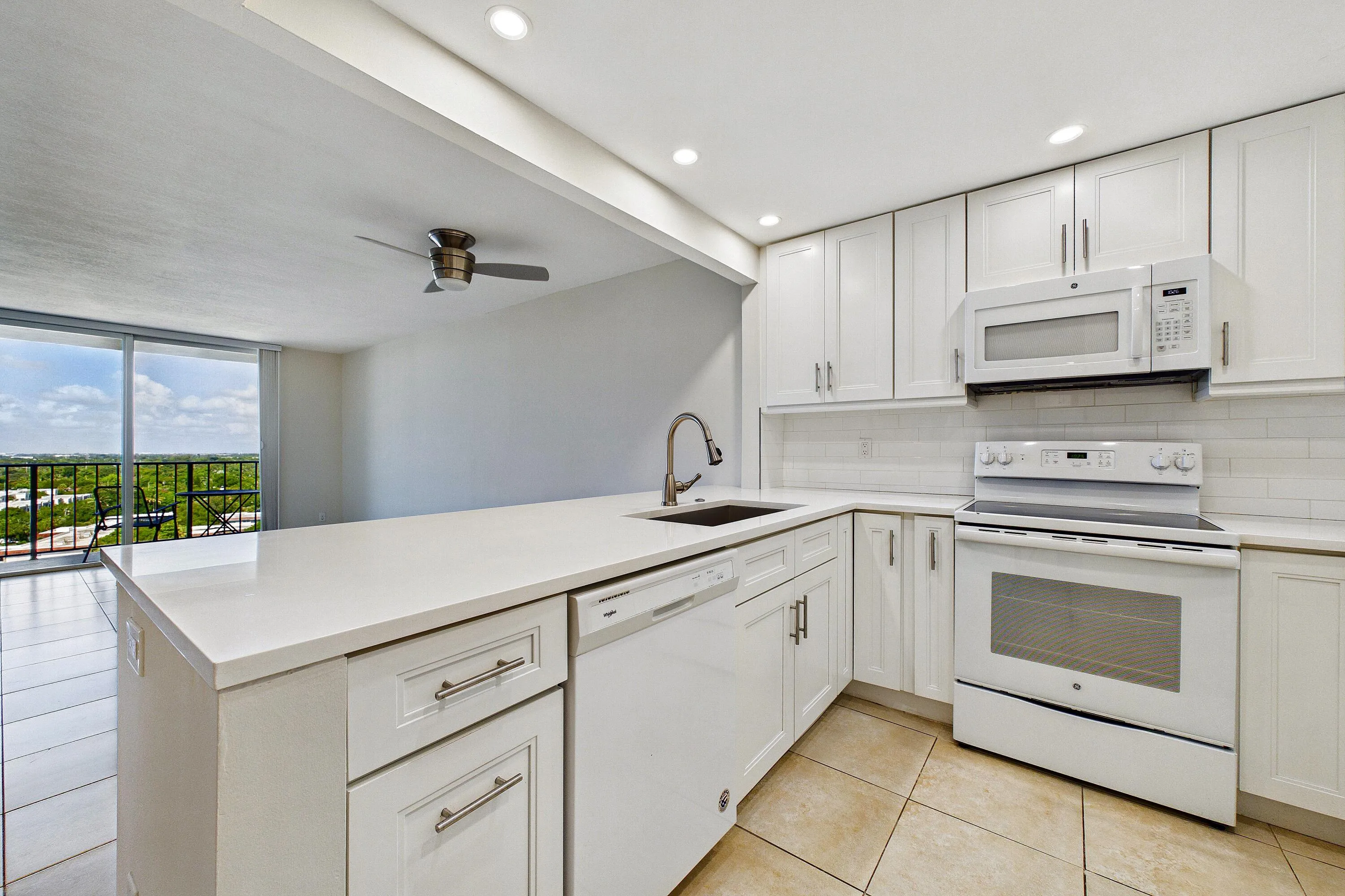 BEAUTIFUL WHITE KITCHEN OPEN TO THE LIVING AREA