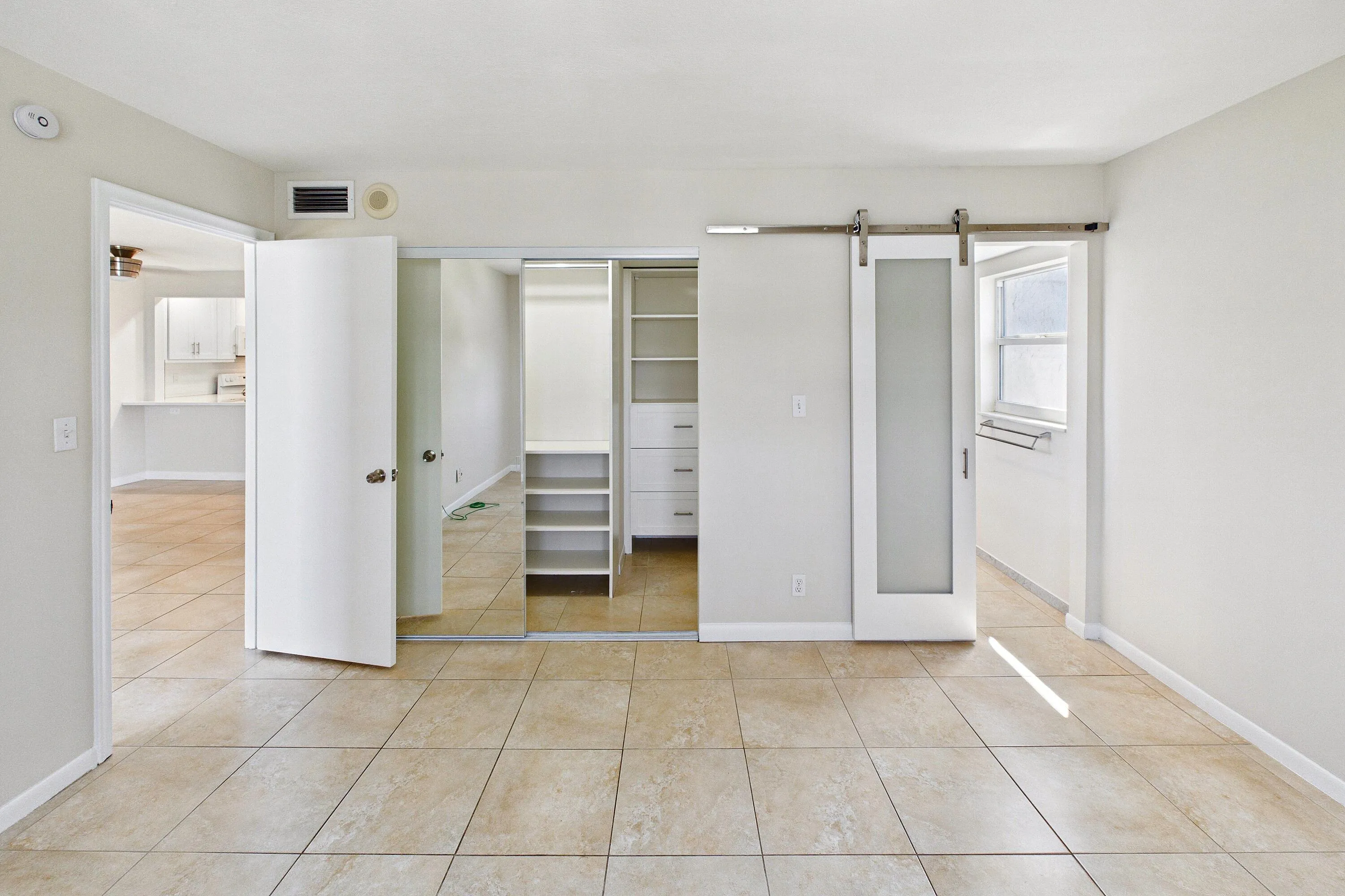 PRIMARY BEDROOM WITH LARGE CLOSET AND BARN DOOR TO BATH