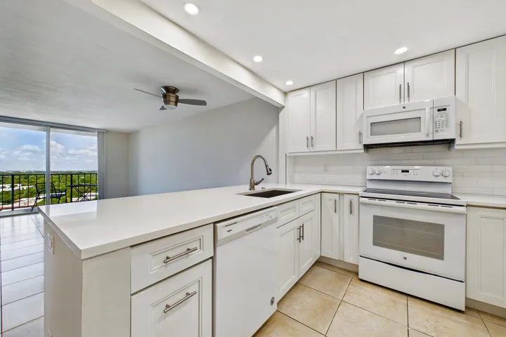 BEAUTIFUL WHITE KITCHEN OPEN TO THE LIVING AREA