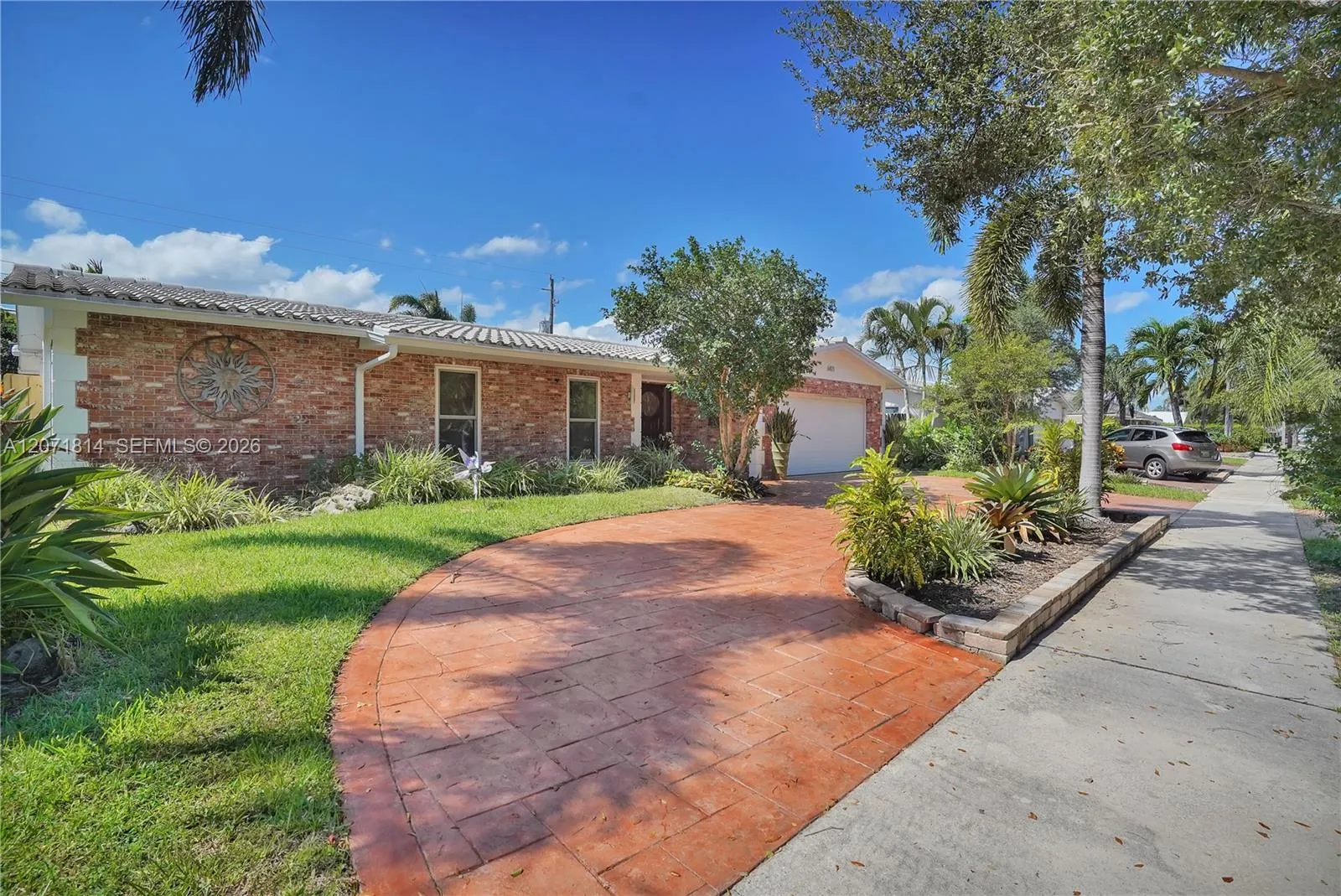 Charming curb appeal with mature landscaping and paved walkway