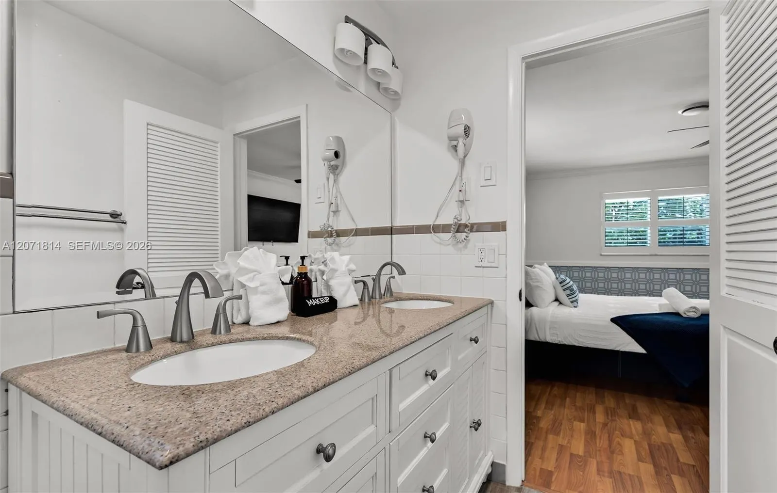 Elegant bathroom with dual vanity and granite countertops