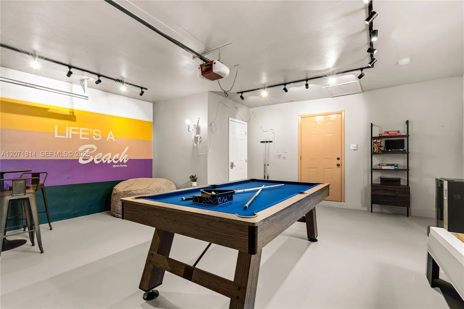 Spacious game room with pool table and vibrant accent lighting