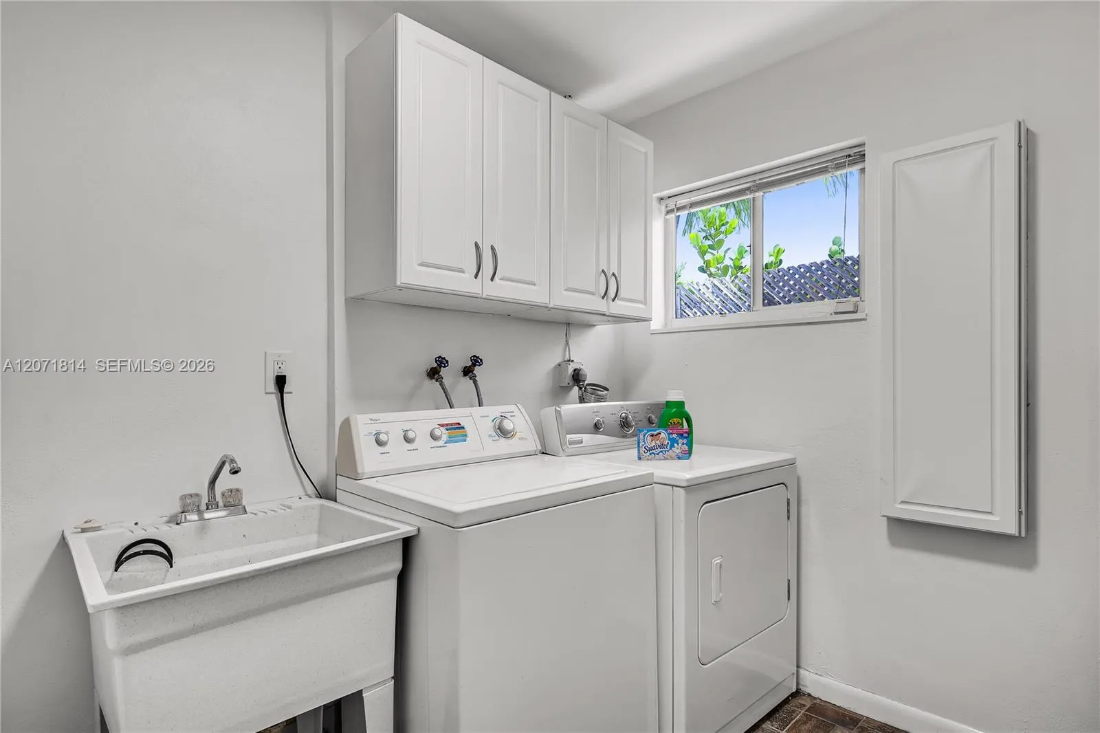 Well-equipped laundry room with built-in cabinetry for extra storage