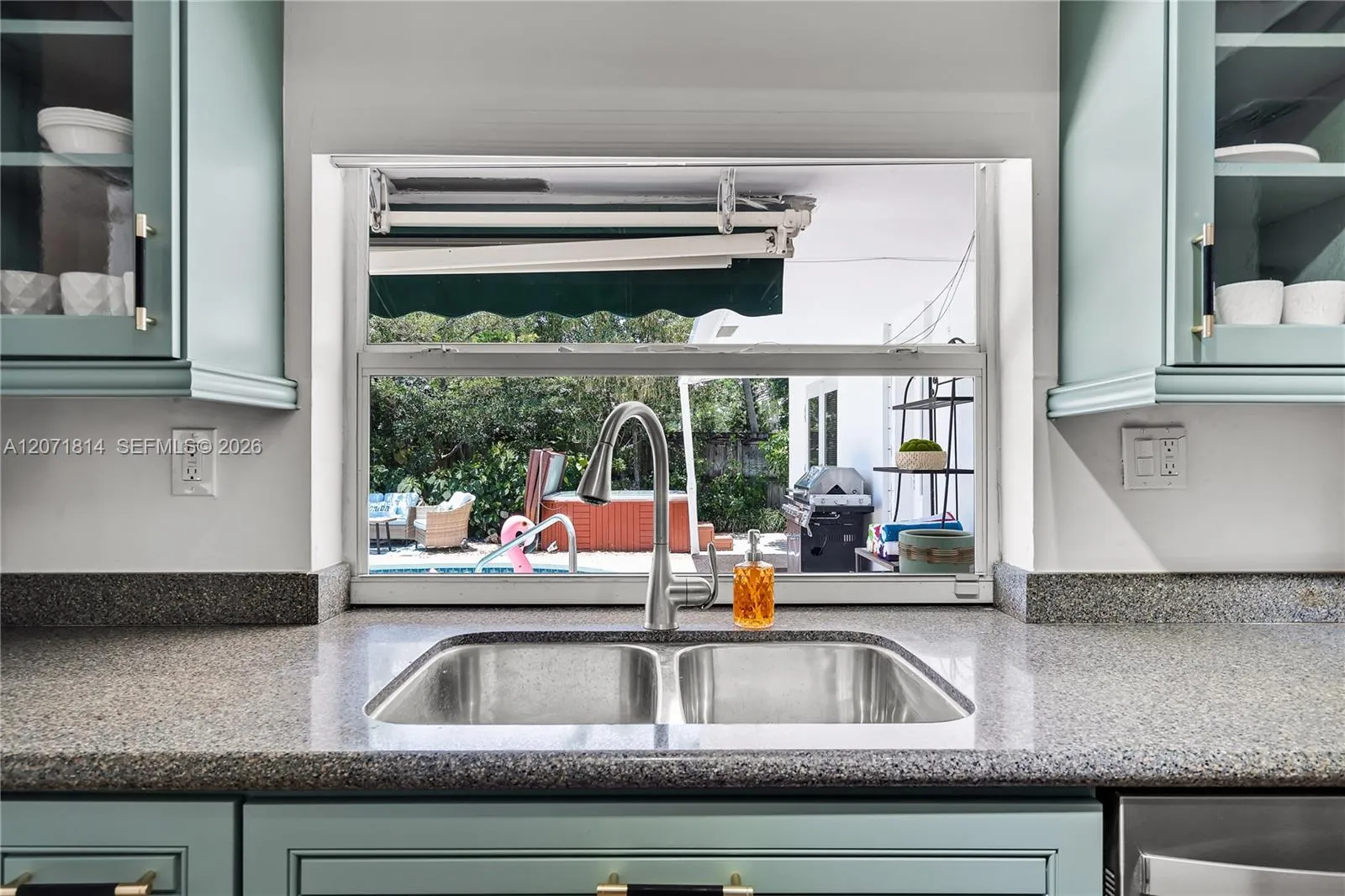 Sleek kitchen featuring quartz countertops and updated cabinetry