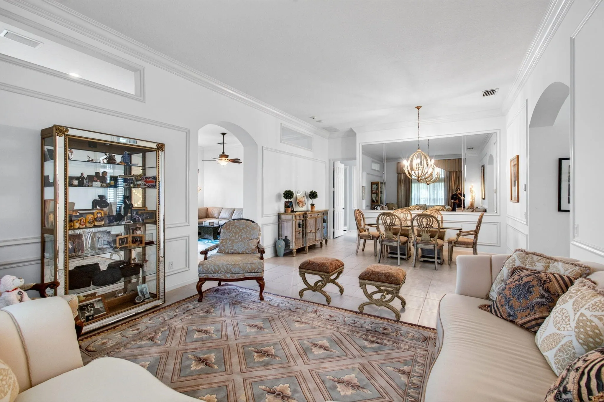 Arched entryway with crown molding and wainscoting