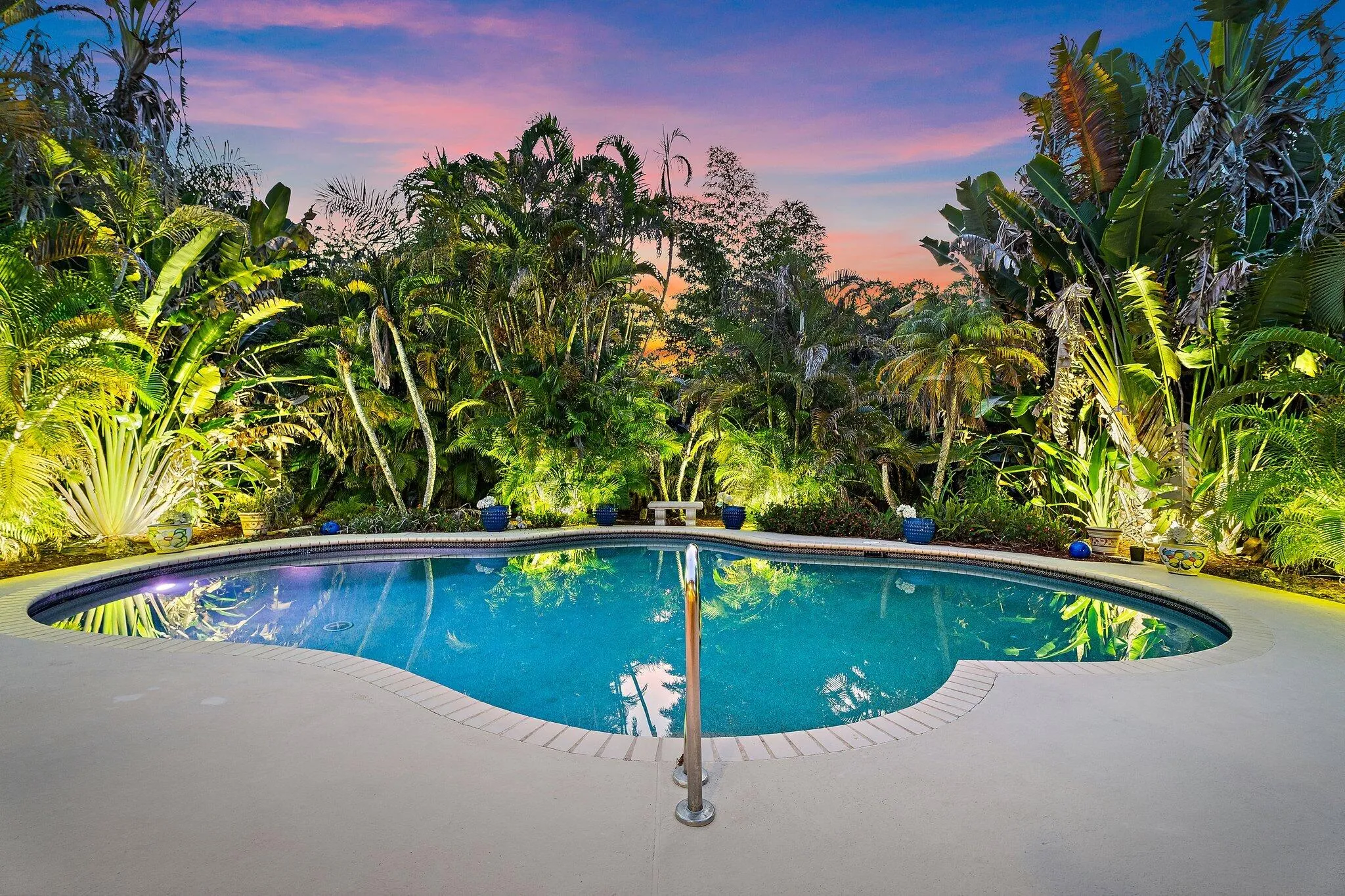 freeform pool is enhanced by tropical landscaping